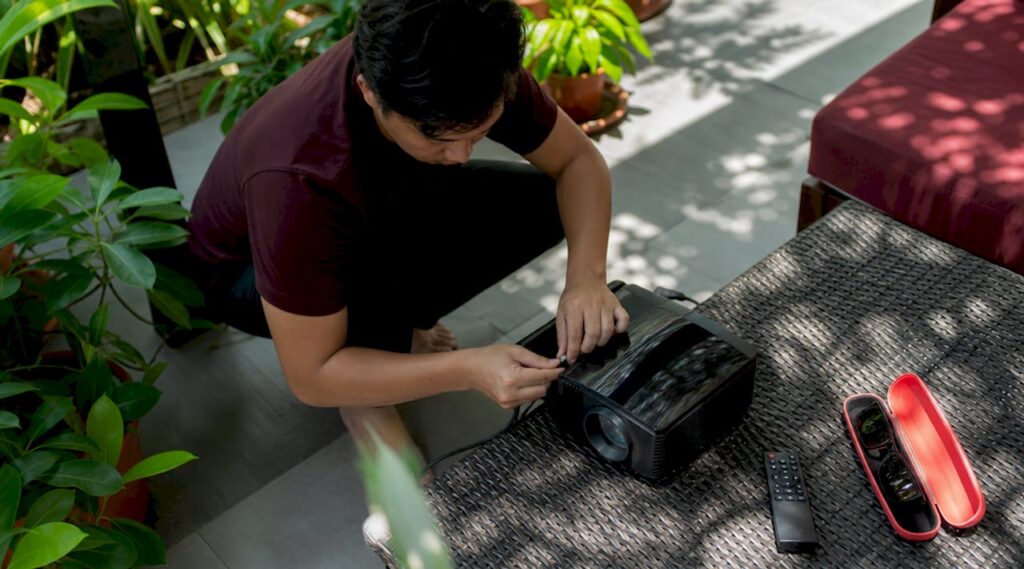 Man setting up Epson 1080p 3D projector